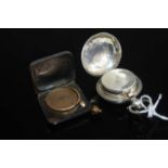 An Edwardian silver sovereign case, having engraved decoration, dia.31mm; together with a steel