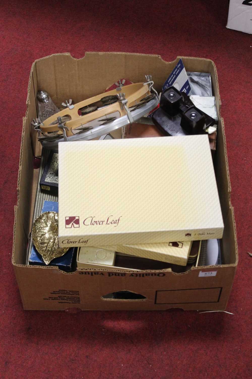 A box of miscellaneous items to include a box of Cloverleaf place mats, a bakelite Viewmaster