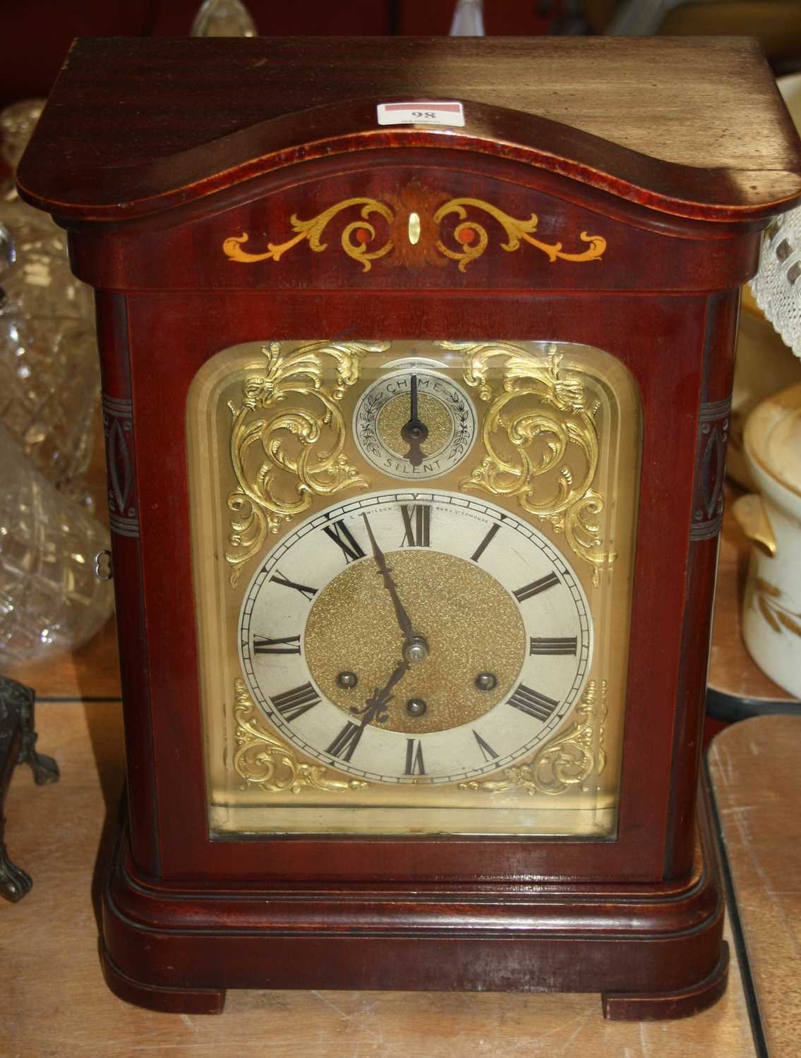 A 20th century mahogany cased eight-day mantel clock, the silvered chapter showing Roman numerals