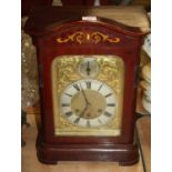 A 20th century mahogany cased eight-day mantel clock, the silvered chapter showing Roman numerals