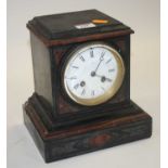 A Victorian black slate and rouge marble eight-day mantel clock, the enamelled dial showing Roman