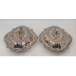 A pair of silver plated entree dishes, each relief decorated with scrolls and flowers, w.33cm