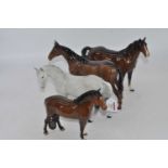 A Beswick model of a mare (facing left), No.976, grey gloss, h.17.5cm; together with three others