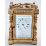 An early 20th century French gilt metal cased carriage clock, the enamelled dial showing Roman