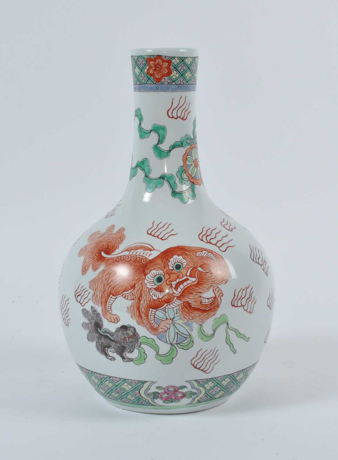 A 20th century Chinese Tianqiuping vase, enamel decorated with dogs of Fo, red enamel four character