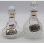 A matched pair of Elizabeth II silver collared cut glass decanters, each bearing a silver collar