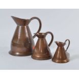 A set of three Victorian copper graduated measuring jugs, the largest h.24cm