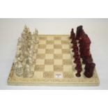 A modern resin 'The Lion, The Witch & The Wardrobe' themed novelty chess set