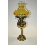 A late 19th century brass oil lamp, having amber tinted glass shade, h.58cm