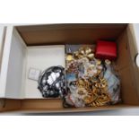 A box of costume jewellery, to include necklaces and brooches