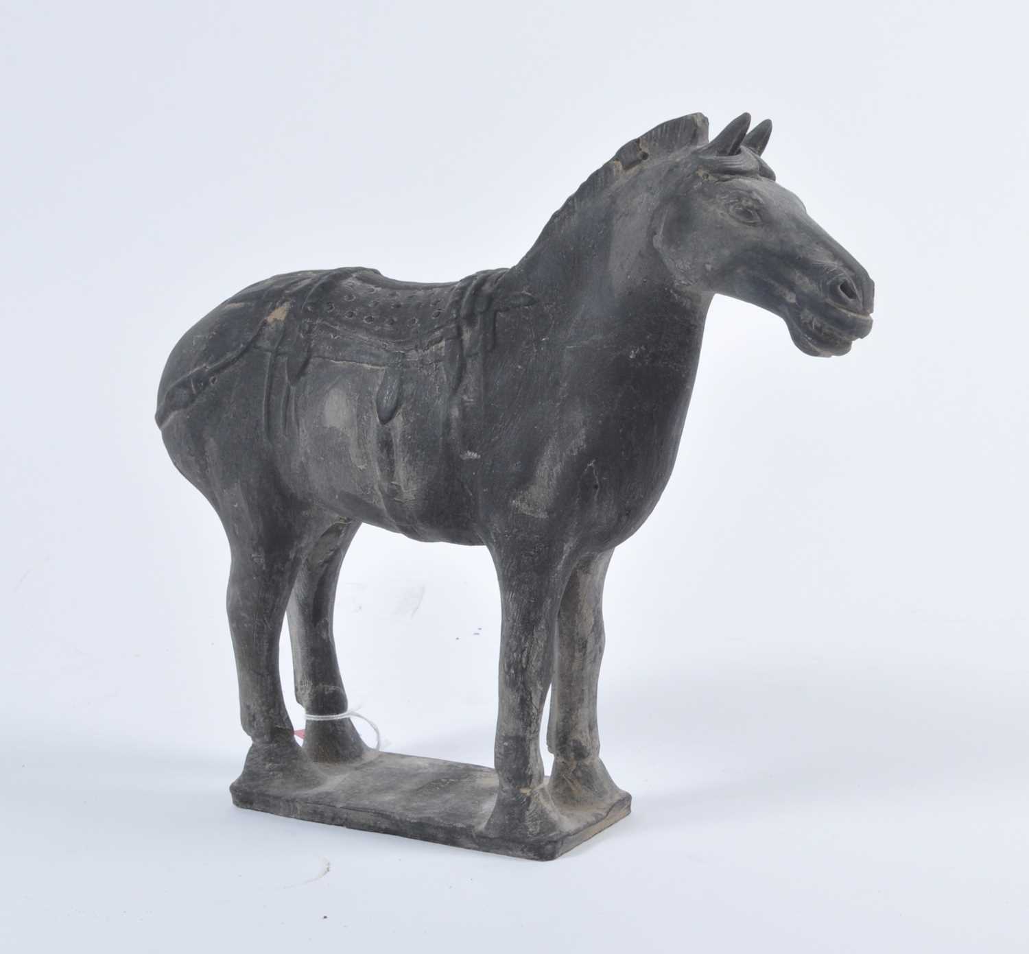 A Chinese hollow moulded black terracotta horse, modelled in standing pose with incised face and