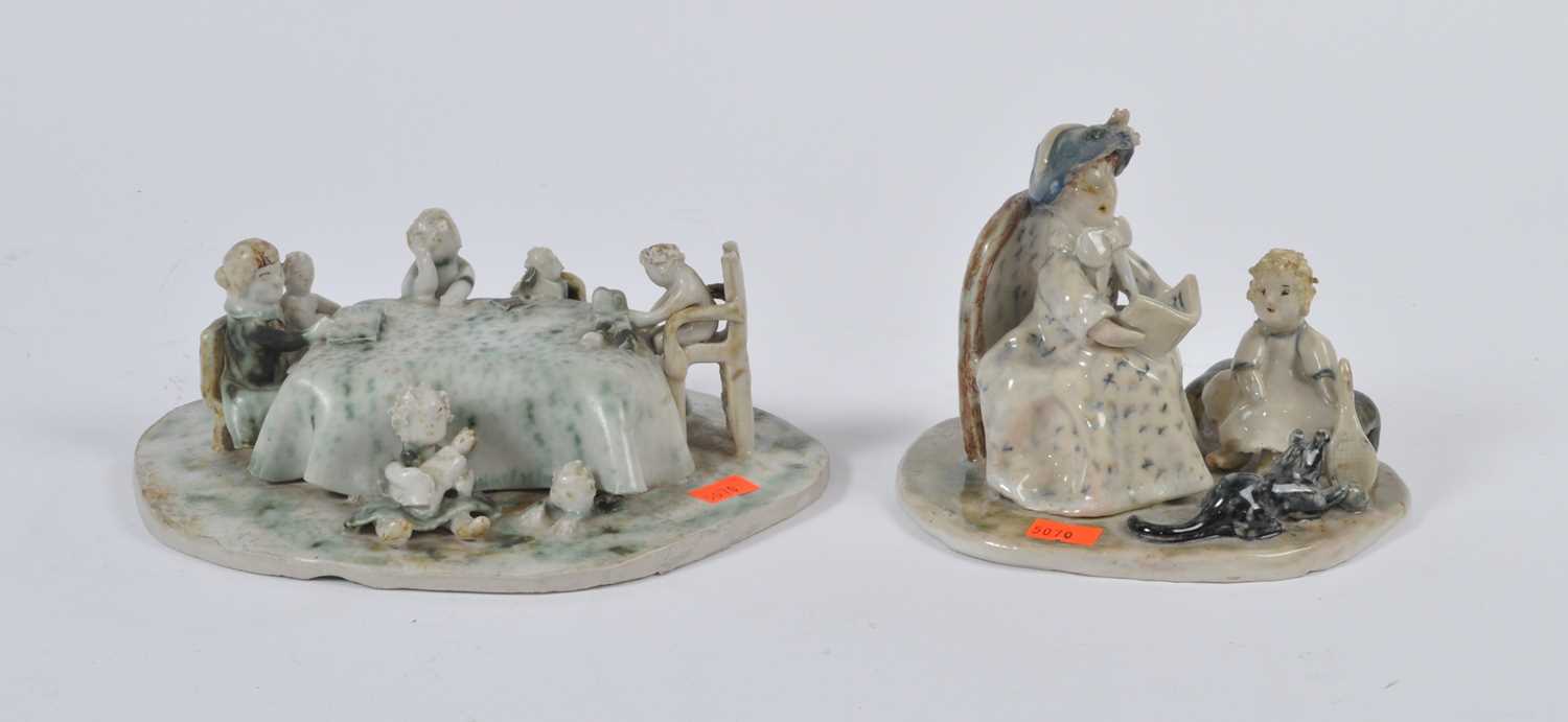 Two studio pottery figure groups, each with mottled green glaze, the largest w.23cm