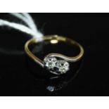 A vintage 18ct gold diamond crossover ring, the two round cuts each weighing approx 0.08 carats, 1.