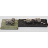 A pair of white metal models of mice, each mounted upon a polished black hardstone plinth, w.16cm;