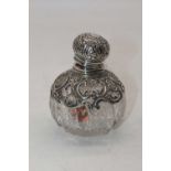 A Victorian silver mounted cut glass scent bottle, the mount with pierced and repousse C-scroll