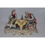 A large Naples style figure group of a couple at dinner, h.22cm