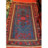 A Persian woollen Shiraz blue ground rug, 195 x 115cm