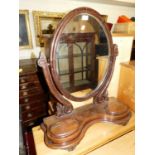 A Victorian mahogany oval swing dressing mirror
