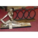 After S Melani - an Art Deco silvered painted plaster figure of a recumbent female with peacock,