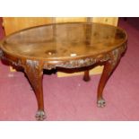 A mahogany acanthus leaf carved oval low occasional table, on slender cabriole supports, width 97cm