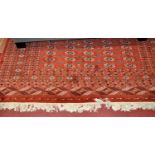 A Persian style red ground woollen Bokhara rug, 280 x 188cmNo stains. Quite a few bald patches