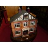 A two-storey open front wooden hand made dolls house titled "Rosydene", width 71cm