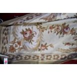 A machine-woven cream ground floral decorated rug, in the Aubusson styleUsed but generally quite