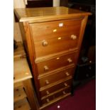 A modern pine narrow chest of four long drawers, having hinged upper compartment, width 61cm