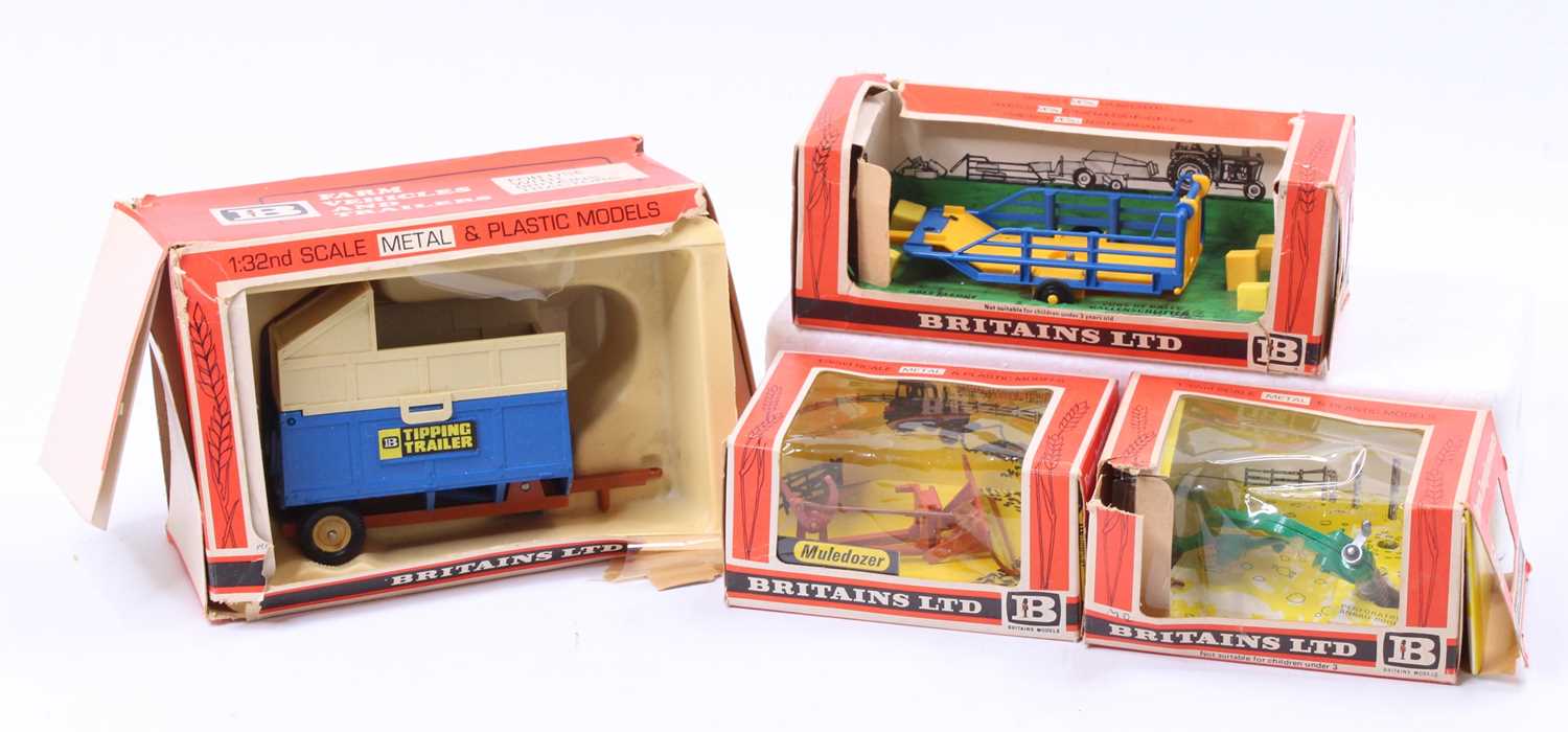 A collection of Britains farm implements and accessories to include a No. 9535 mule dozer, a No.