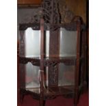 A circa 1900 fret carved mahogany mirrored three-tier wall shelf, of credence shape, width 50cm (