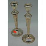 A pair of Victorian silver table candlesticks, Birmingham 1867, 24cm high each (loaded)