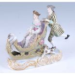 A late 19th century Dresden porcelain sleigh group, modelled as a skating gallant and his maiden