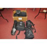 A collection of various photography equipment travel bags to include Lowe Pro