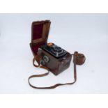 A Yashica-A camera, housed within a tan leather travel case