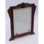 An Art Deco walnut easel photo frame of shaped rectangular form having a shell carved crest,