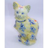 A large reproduction Galle style cat modelled in seated pose on yellow ground with blue floral