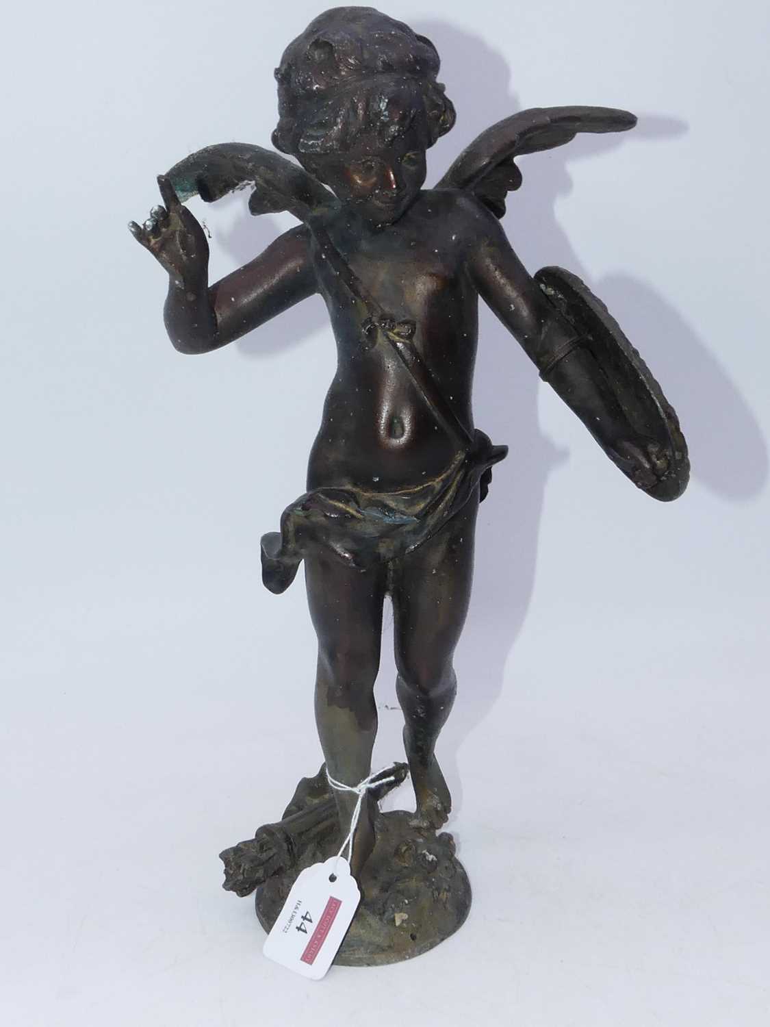 An early 20th century spelter figure of cupid in typical standing pose with shield upon his arm,