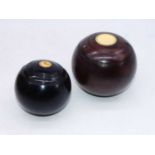 A pair of lignam vitae lawn bowls; together with a pair of ebonised lawn bowls and Jack by Ayres