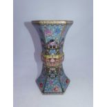 A reproduction Chinese vase, of hexagonal gu shape, enamel decorated with flowers on a blue ground