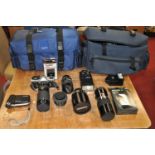 A collection of various photography equipment to include a Tamron 500mm macro camera lens, and a