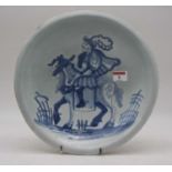 A 17th century Delft charger, underglazed blue decorated with a figure upon horseback, 31cm (heavily