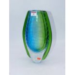 A large green and blue tinted art glass vase of shaped oval form having bubble inclusions, unmarked,