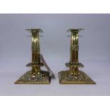 A pair of Victorian repousse decorated brass table candlesticks, h.21cm