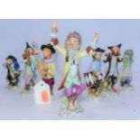 A collection of seven continental porcelain monkey band figures, after the Meissen originals,