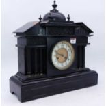 A large late Victorian black slate mantel clock, of architectural form, having an enamelled