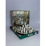 A collection of Oakley porcelain thimbles; together with three display cases