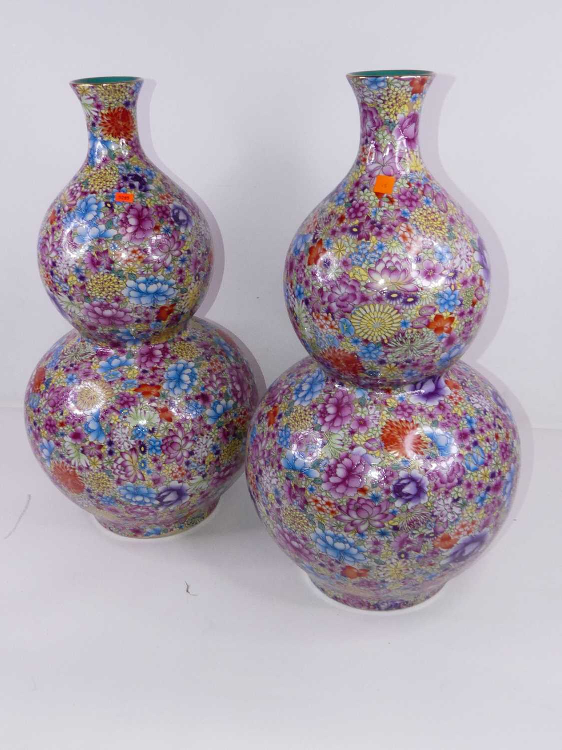 A pair of large reproduction double-gourd vases, enamel decorated with flowers in shades of pink,