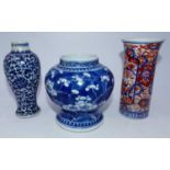 A Chinese export blue and white jar, of squat baluster form, decorated with prunus, having Greek Key