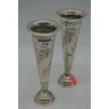 A pair of Victorian specimen vases, each repoussee decorated with flowers, marks rubbed, height 19.