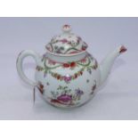 An 18th century Lowestoft teapot and cover, of bullet shape, hand-painted with flowers and